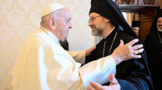 Pope Francis greets Archbishop Job of Pisidia, delegation leader. Image Vatican Media