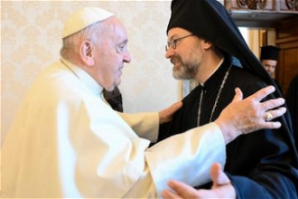 Pope Francis greets Archbishop Job of Pisidia, delegation leader. Image Vatican Media