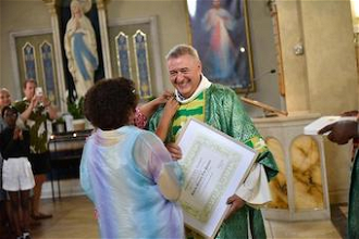 Andrea pins the  Benemerenti medal  on Rev Tito