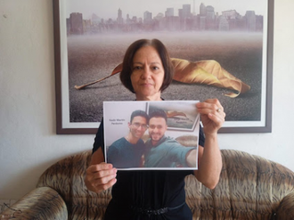 Martha Perdomo holds photo of her sons Jorge Martin and Nadir. Image: Martha Perdomo