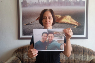 Martha Perdomo holds photo of her sons Jorge Martin and Nadir. Image: Martha Perdomo