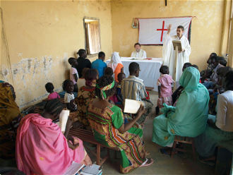 Comboni Father Jorge Naranjo seen here with his community in Sudan © ACN