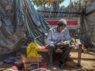 Man reading a Bible, Credit ACN