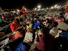 Pilgrims playing cards during the night