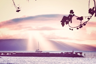 Boat sailing by old Lahania Luau. Photo by Max Harlynking on Unsplash