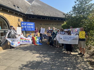 Tobi holds the 'Columban Missionaries' banner at St Anne's church