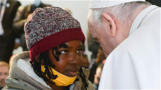 Pope Francis greets  young migrant during his visit to Mytilene Refugee Camp in 2021  (Vatican Media)