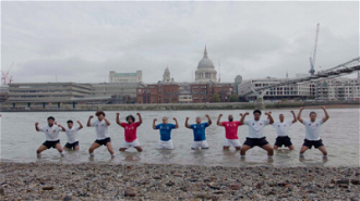 Pacific Islanders performing traditional dance as waters rise in River Thames, London
