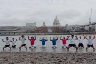 Pacific Islanders performing traditional dance as waters rise in River Thames, London