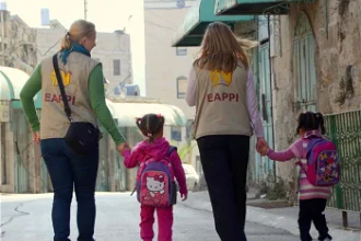 EA volunteers escort children to school in Hebron