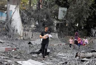 Family walk through rubble of their neighbourhood