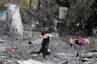 Family walk through rubble of their neighbourhood