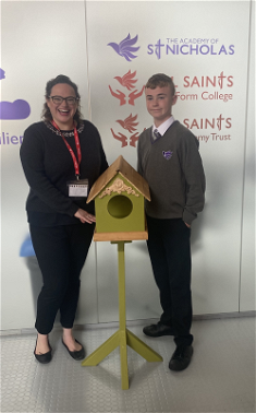 Kate Martinez from the Palm House with St Nicholas Academy student Cody, and his beautiful bird table