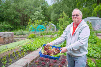 Caritas volunteer working in allotment which provide food for the Caritas food pantry