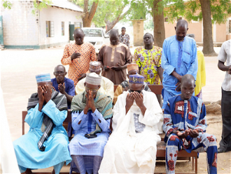 Nigerian community leaders pray together © ACN