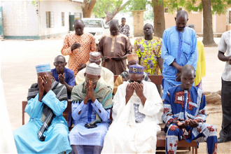 Nigerian community leaders pray together © ACN