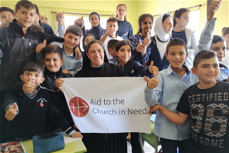 Pupils and teacher at school run by Good Service Sisters in Lebanon © ACN