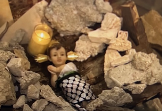 Figure of Baby Jesus in the rubble in Lutheran church crib, Bethlehem. Screenshot