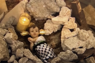Figure of Baby Jesus in the rubble in Lutheran church crib, Bethlehem. Screenshot