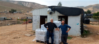 Rabbi Dani Danieli and Anton Goodman of RHR deliver aid to communities in South Jordan Valley.