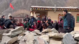 Monks and residents of Upper Wonto Village plead with officials outside Yena Monastery