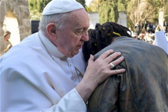 Pope with young migrant. Image: Vatican Media