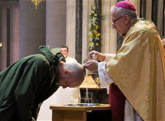 Bishop Peter Collins baptises a new Catholic at the Easter Vigil,  St John's Cathedral, Norwich.
