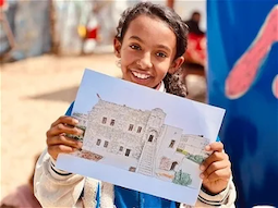 Amal with her picture of Qasr Al-Basha