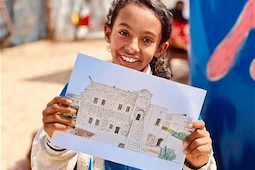 Amal with her picture of Qasr Al-Basha