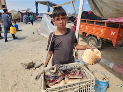 Youssef (13) carrying bread for his family in Al Mawasi. Photo by UNICEF