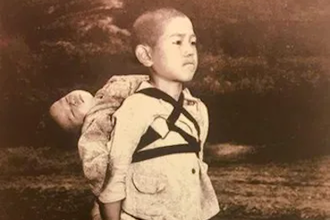 'The fruits of war.' Pope Francis World Day of Prayer for Peace 2017 prayer card. Photo by Joseph Roger O'Donnell of young Japanese boy waiting at crematorium with his dead younger brother on his back. Source: Vatican Media