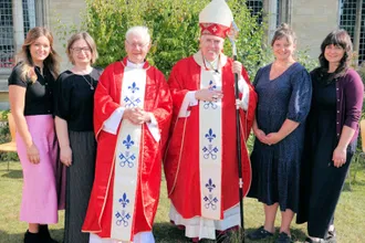 Father John Morrill  and his four daughters with Bishop Peter Collins. Image Diocese of East Angla