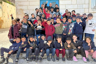 Fr Mamdouh Abusada with  some of the children. Image: School of Joy