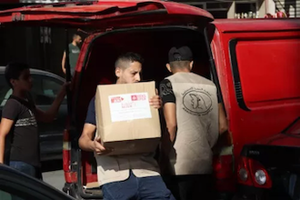 Essential supplies being distributed to new arrivals at Nahr el-Bared Palestinian refugee camp near Tripoli. Image: Christian Aid/Najdeh