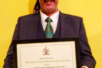 Tyrone Allee with his Black History Month Collaborative Partnership Award, for services to the community as a Notting Hill Carnival Ambassador.