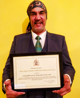 Tyrone Allee with his Black History Month Collaborative Partnership Award, for services to the community as a Notting Hill Carnival Ambassador.