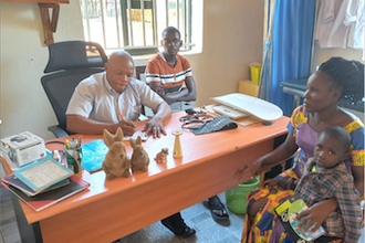 Fr Avelino with visitors in Ave Maria parish office