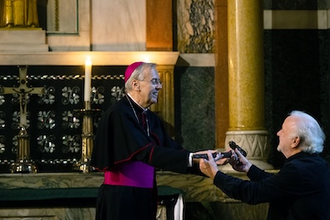 Descendant of Daniel O'Sullivan presents the walking stick to Bishop Hudson. Image: CBCEW