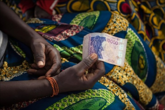 Woman at microfinance meeting in Niger, supported by World Renew. Photo: Sean Hawkey/Life on Earth