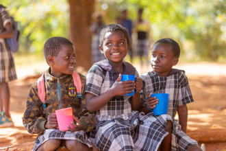 Children enjoying their porridge from Mary's Meals