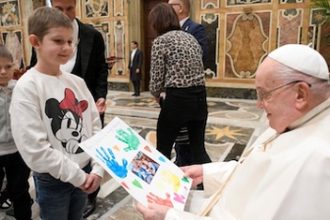 Child presents Pope Francis with a picture