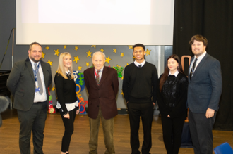 Tomi Komoly (centre) with pupils and staff at St John Plessington Catholic College