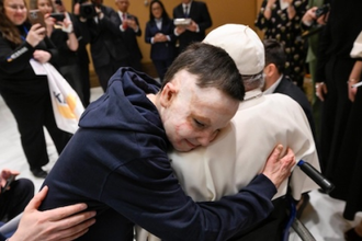 Young burn survivor shares a hug with Pope Francis  during Summit on Children's Rights