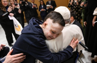 Young burn survivor shares a hug with Pope Francis  during Summit on Children's Rights