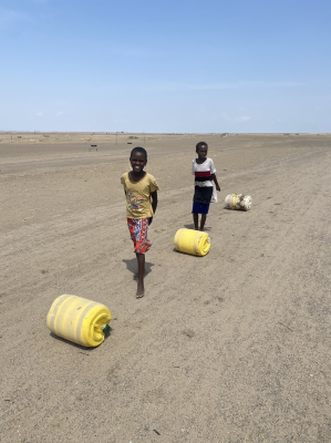 Children with water barrels