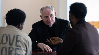 Bishop Paul talks with asylum seekers