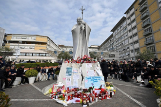 Pilgrims pray outside Gemelli Hospital