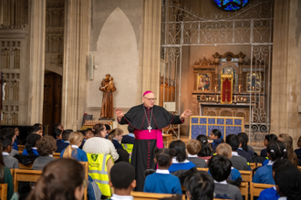 Archbishop speaks with children before the service