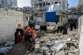 Gaza children on the wreckage of their home. Photo by Mohammed Ibrahim on Unsplash