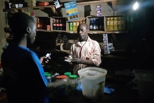 A family uses solar lights to run their shop at night. Before they had to close by 6pm
